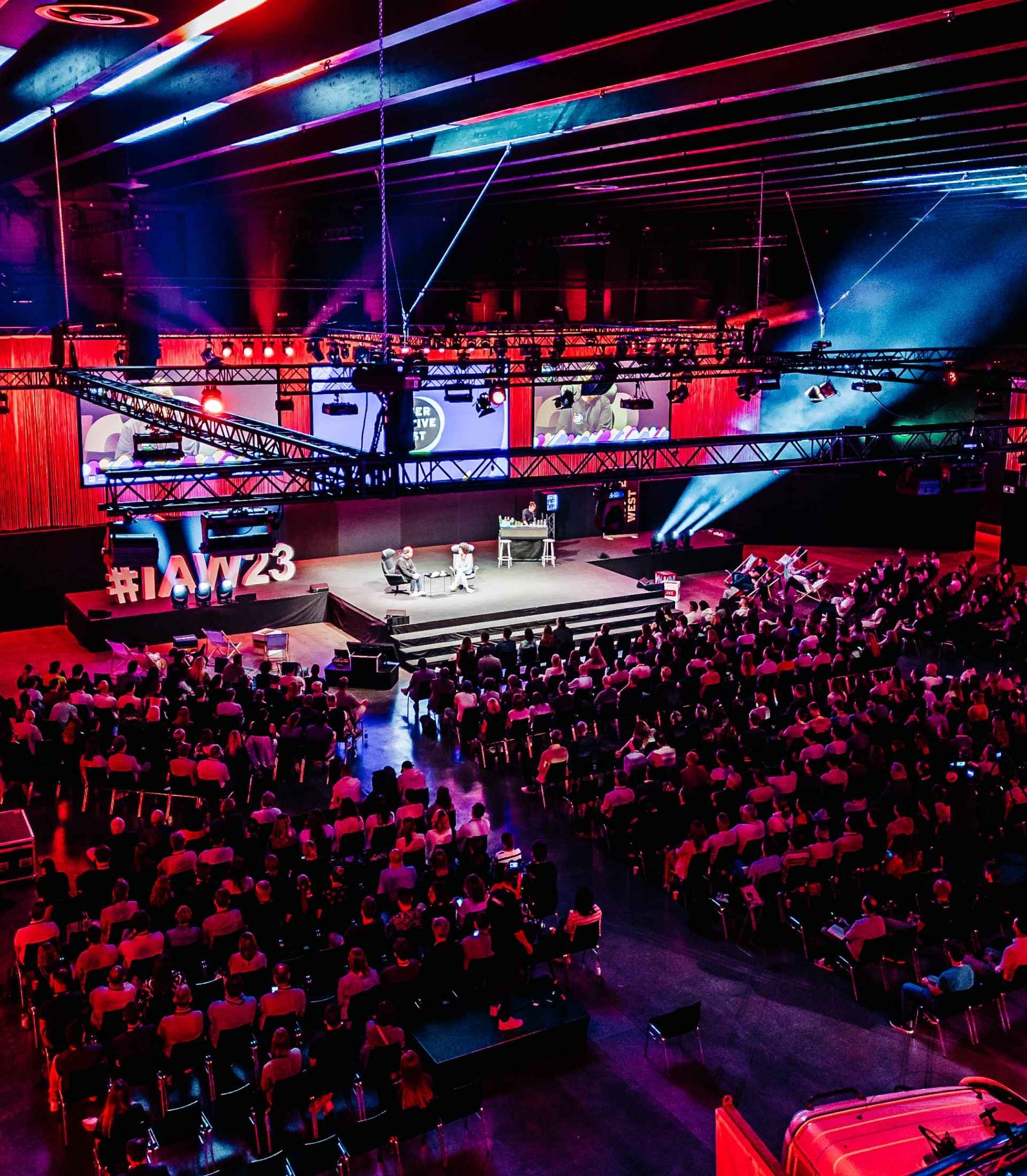 Bild von der Bühne bei der Interactive West - Spektakulär beleuchtet in rot und blau von PeterLine Showtech